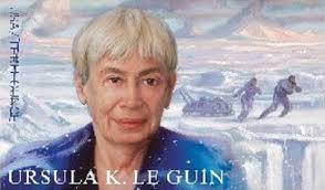 Ursula Leguin postage stamp. Leguin in the foreground. Two figures pull a sledge across a glacier in back